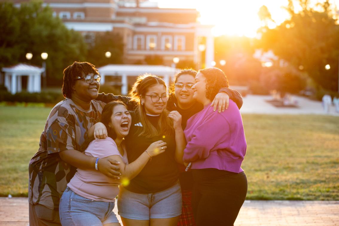 Longwood seniors laugh together on campus during Senior Sunrise.