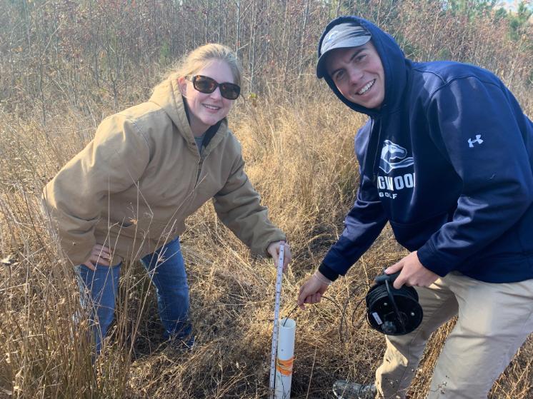 Dr. Kathy Gee working with a Longwood student in the field