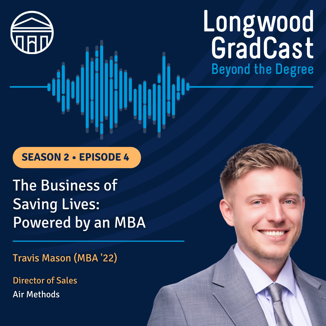 Travis - Two individuals shake hands on stage during a formal ceremony.   One wears academic regalia with a medallion; the other holds a framed certificate.   Banners with “COLLEGE” and column emblems are visible in the background.   Both are smiling, marking a moment of recognition or achievement.