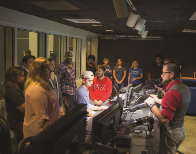 Clint Wright (right), broadcast studio managing editor, is the coach for a group of freshmen who have a shared interest in film and movies. As an outgrowth of their coaching group, these students created an improv show called ‘Skit Happens’ that they write, act in, film and edit. (Photo courtesy of Hiba Abu Chabke ’19)