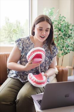 Kathryn Cook Holding a set of giant teeth