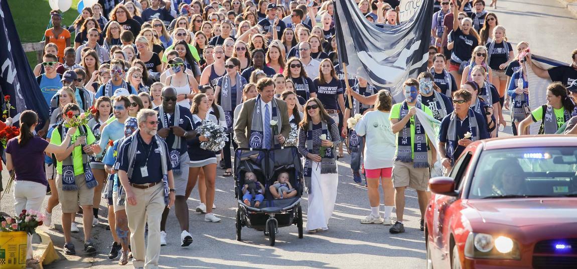 President Reveley and his wife, Marlo, lead the march during The G.A.M.E. (Greatest Athletics March Ever)