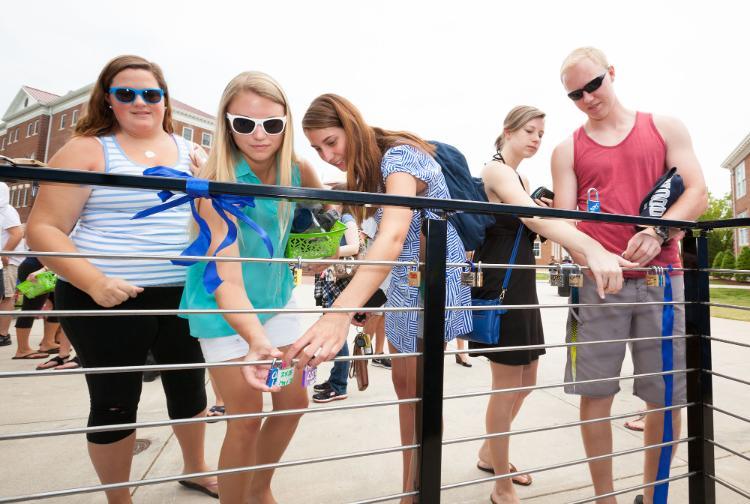 Students attach locks as part of a tradition that began in 2015