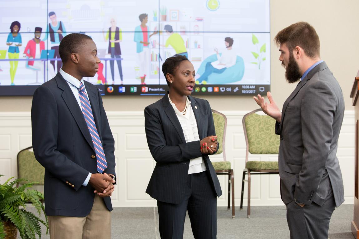 Longwood junior Joseph Hyman speaks with Traci DeShazor, deputy secretary of the commonwealth, and Praise Nyambiya after a roundtable discussion on boosting millennial civic engagement hosted by Longwood last fall.