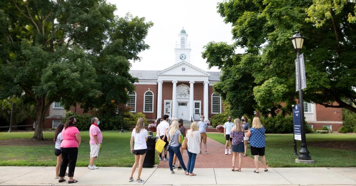 Families taking a tour of Longwood in front of Lancaster Hall