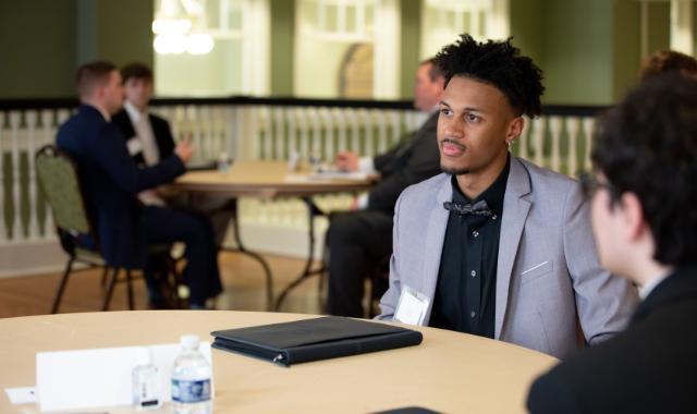 Business students engage in mock interviews as part of a course to develop workplace skills