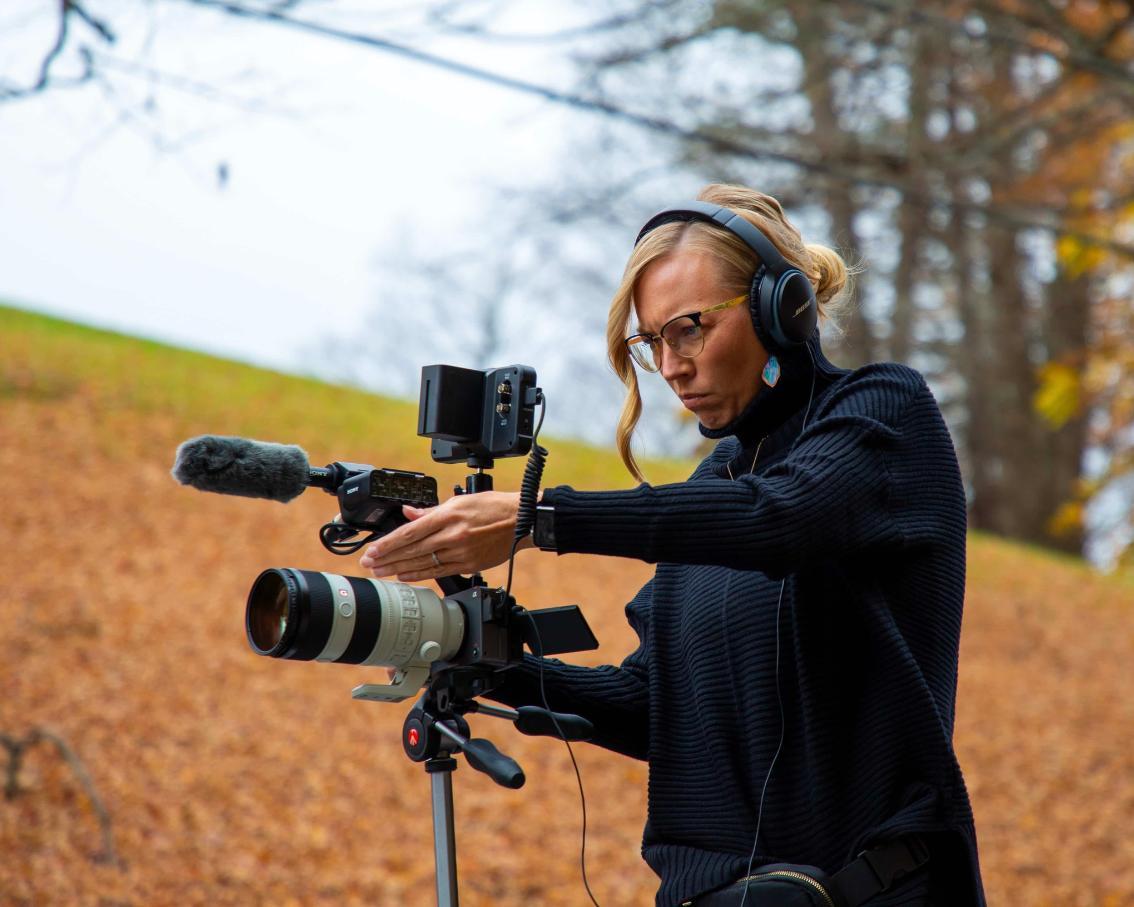 Amy Perez adjusts the focus of her camera, preparing to film portion of film