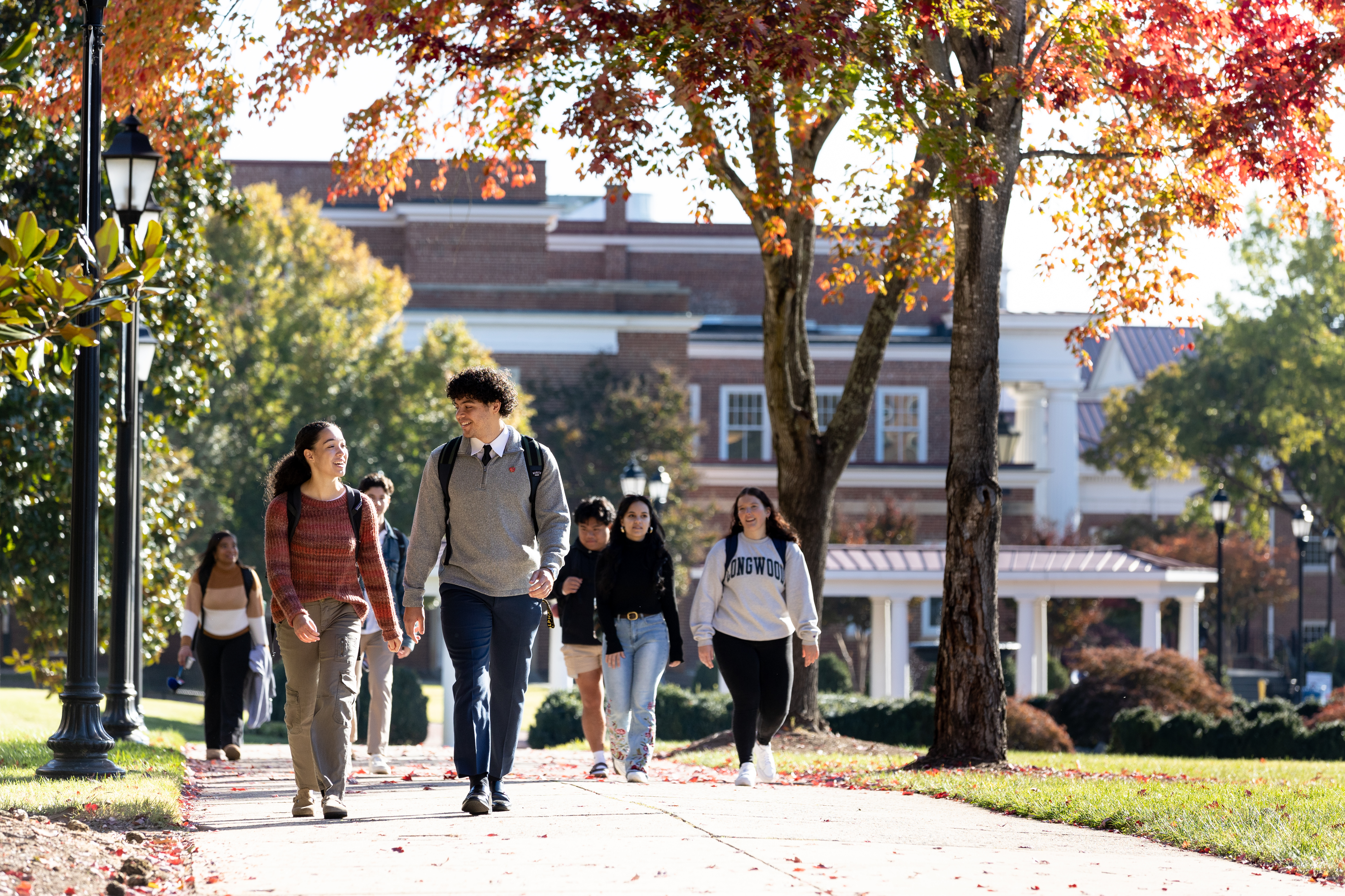Students walking behind Eason during the fall