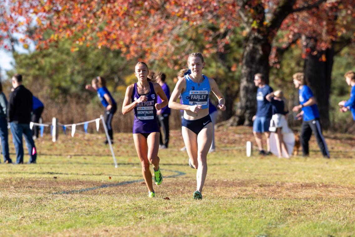 Born with a brain condition known as PMG, Sophie Farley ’28 (right) has thrived as a member of Longwood’s cross country and track program and found herself in the process. (Photo credit: Big South Conference)