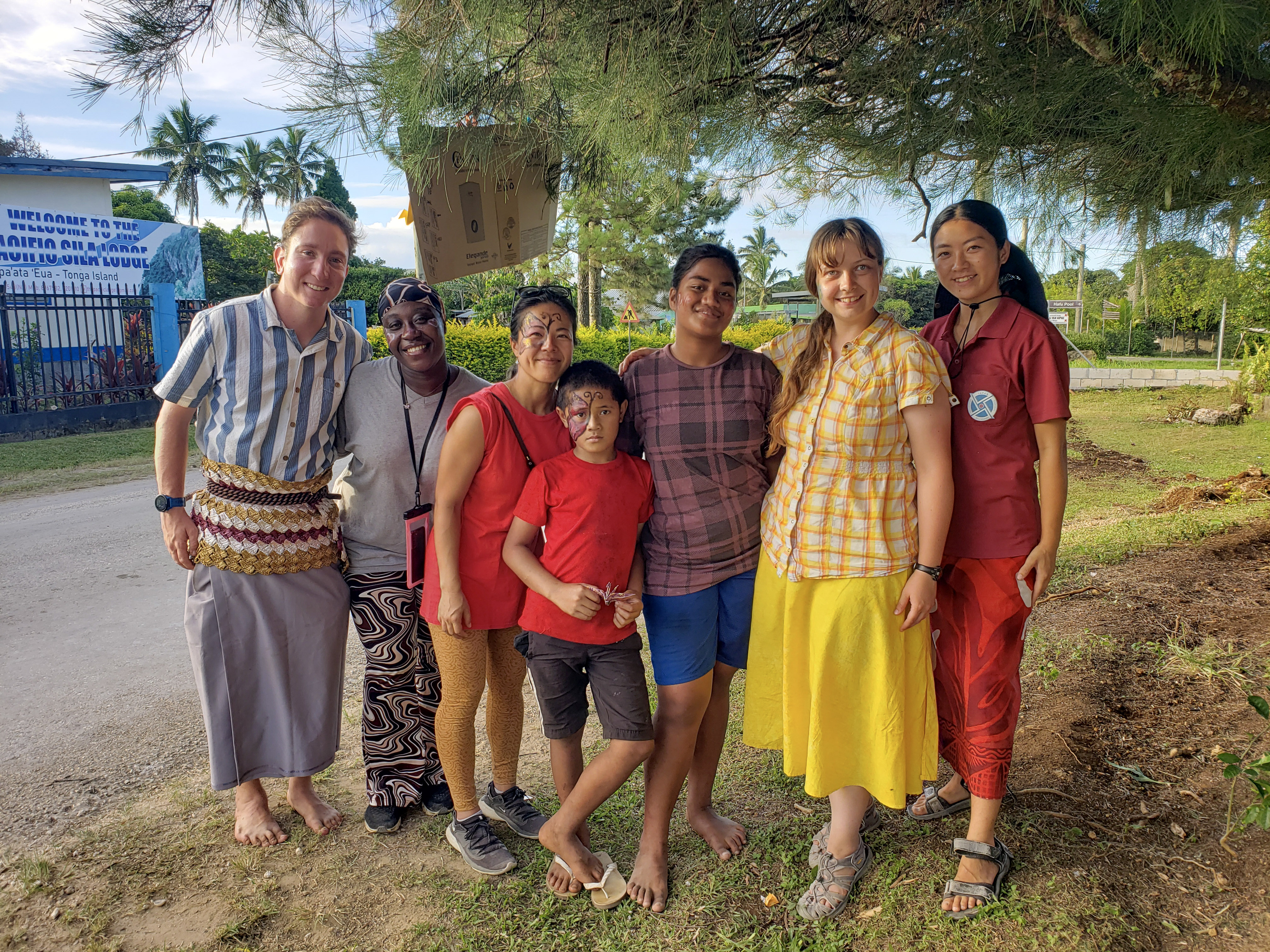 Taylor Bauer '20, M.S. '21 (second from right) stands with Tongan friends, neighbors and fellow Peace Corps volunteers she's met during her time on the island of 'Eua.