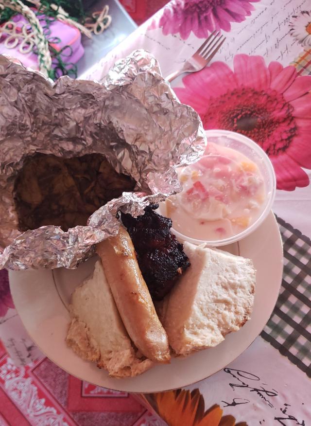 A plate of Tongan food, including lu (pronounced loo), a traditional after-church meal served in tinfoil.