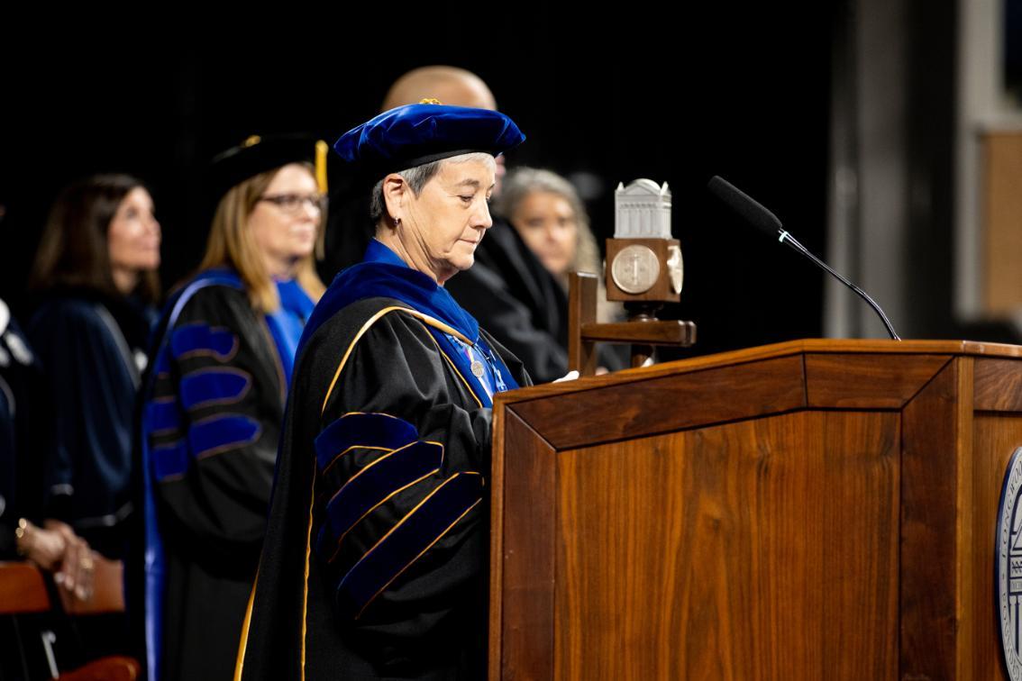 Longwood's chief faculty marshal and professor of school librarianship, Dr. Audrey Church, opens Convocation 2026 after placing the university mace (behind Dr. Church) in its stand.