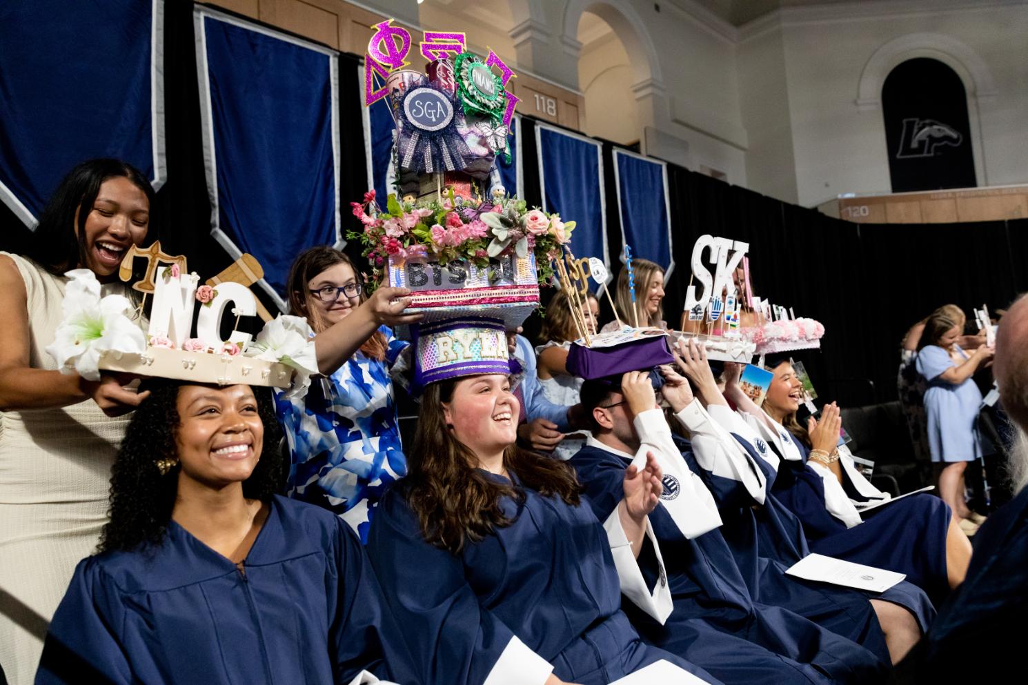 Members of the Senior Class Council get capped by their cappers on the Convocation platform